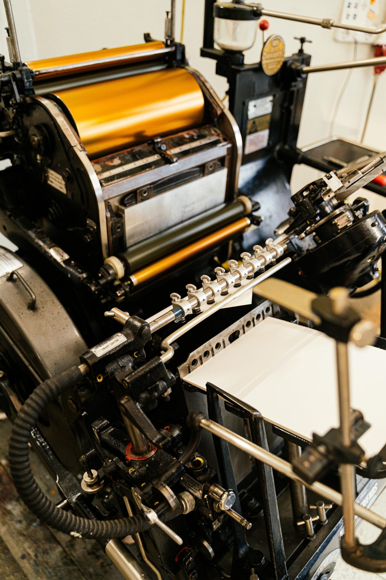 Detailed view of an old-fashioned printing press showing industrial machinery.